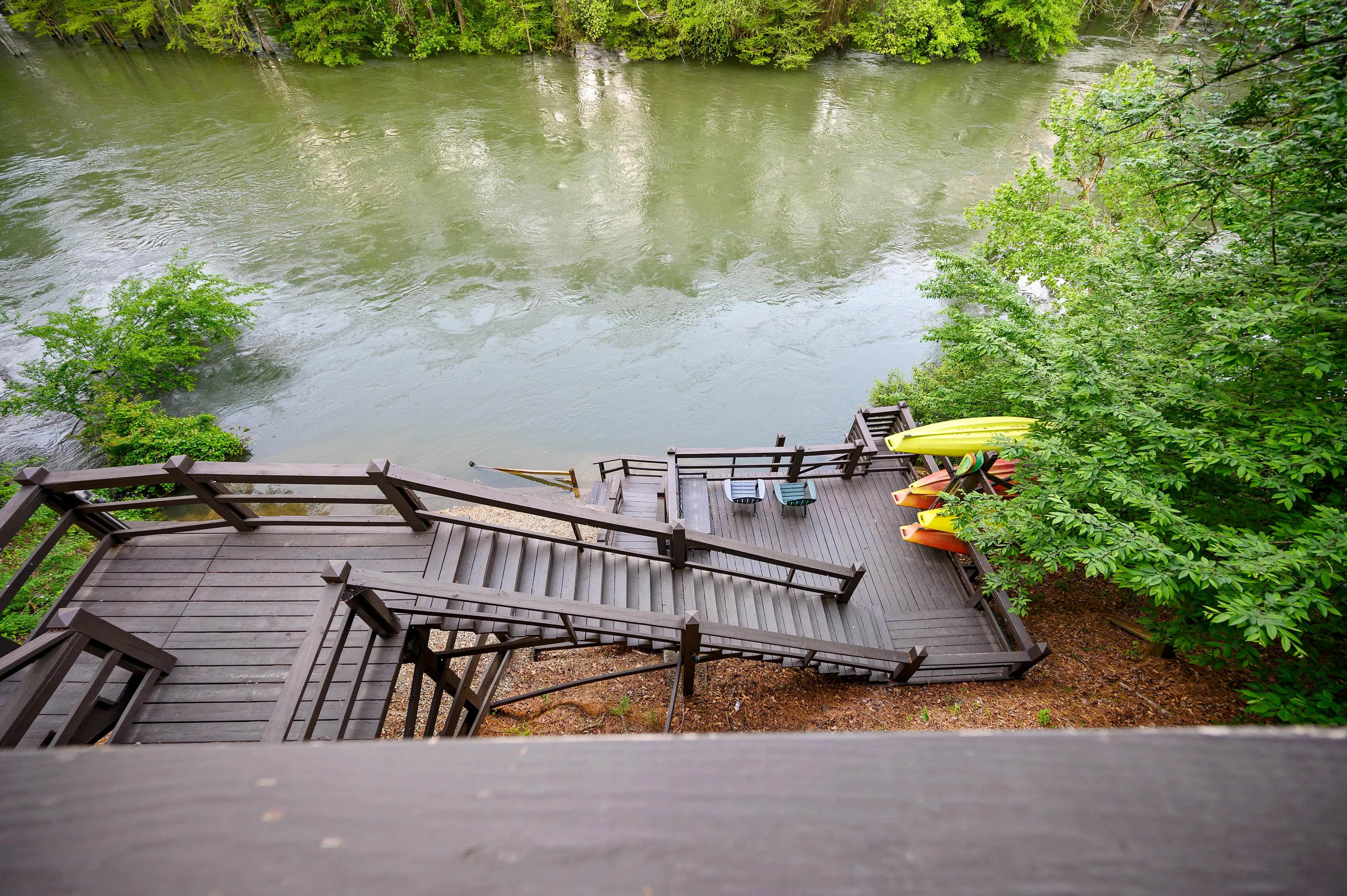 Welcome to Kingfisher with a deck leading the Mountain Fork River!