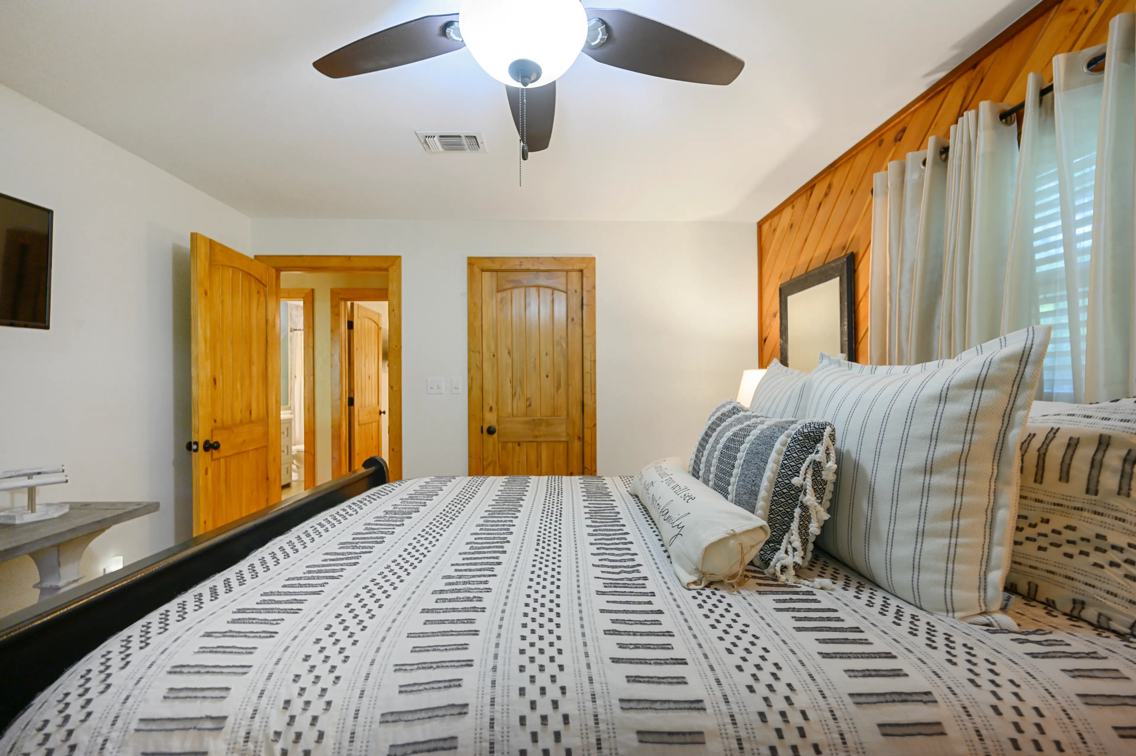The bath is just across the hall from this queen bedroom.