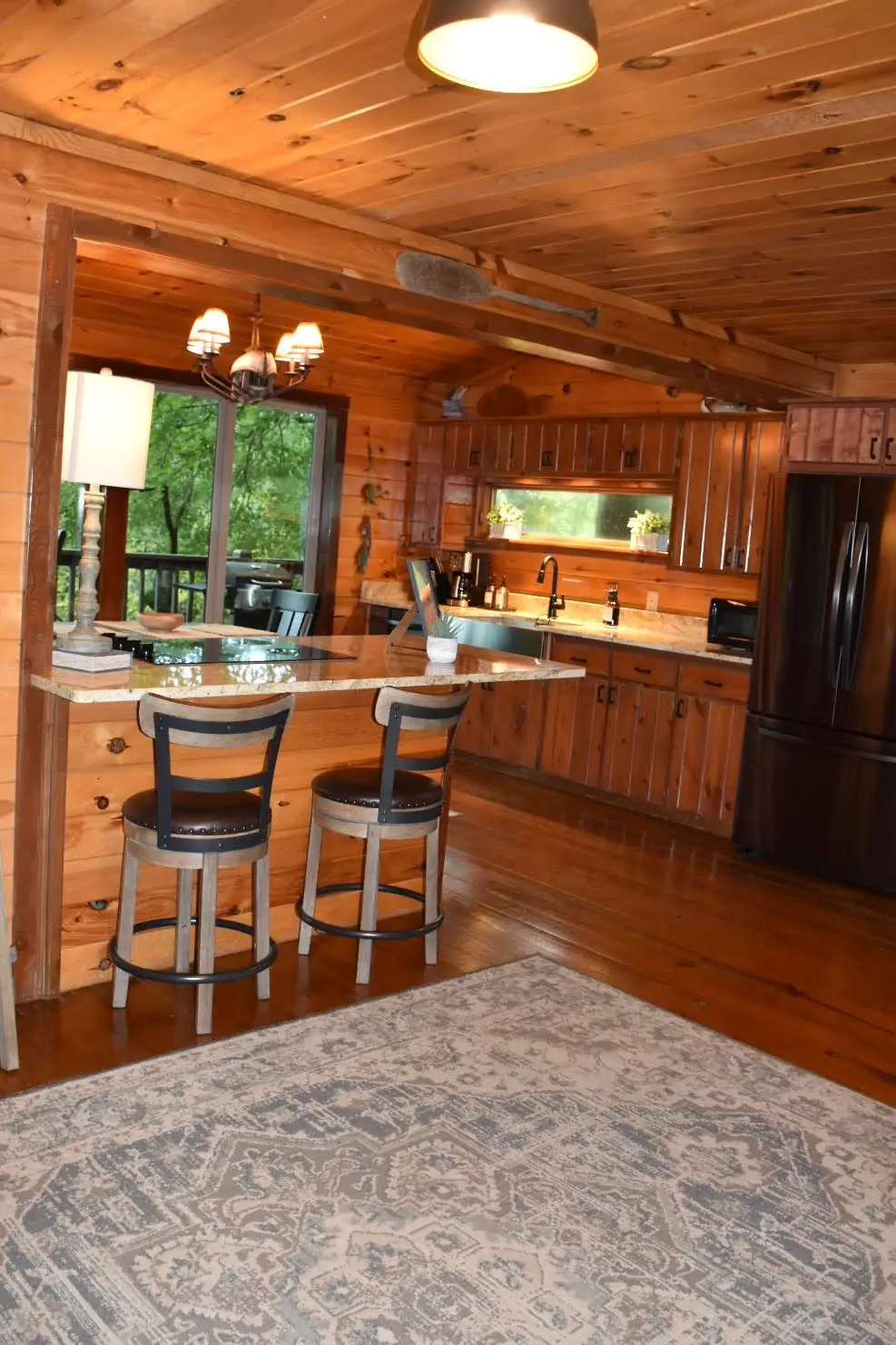 The kitchen with bar seating and a table for 4