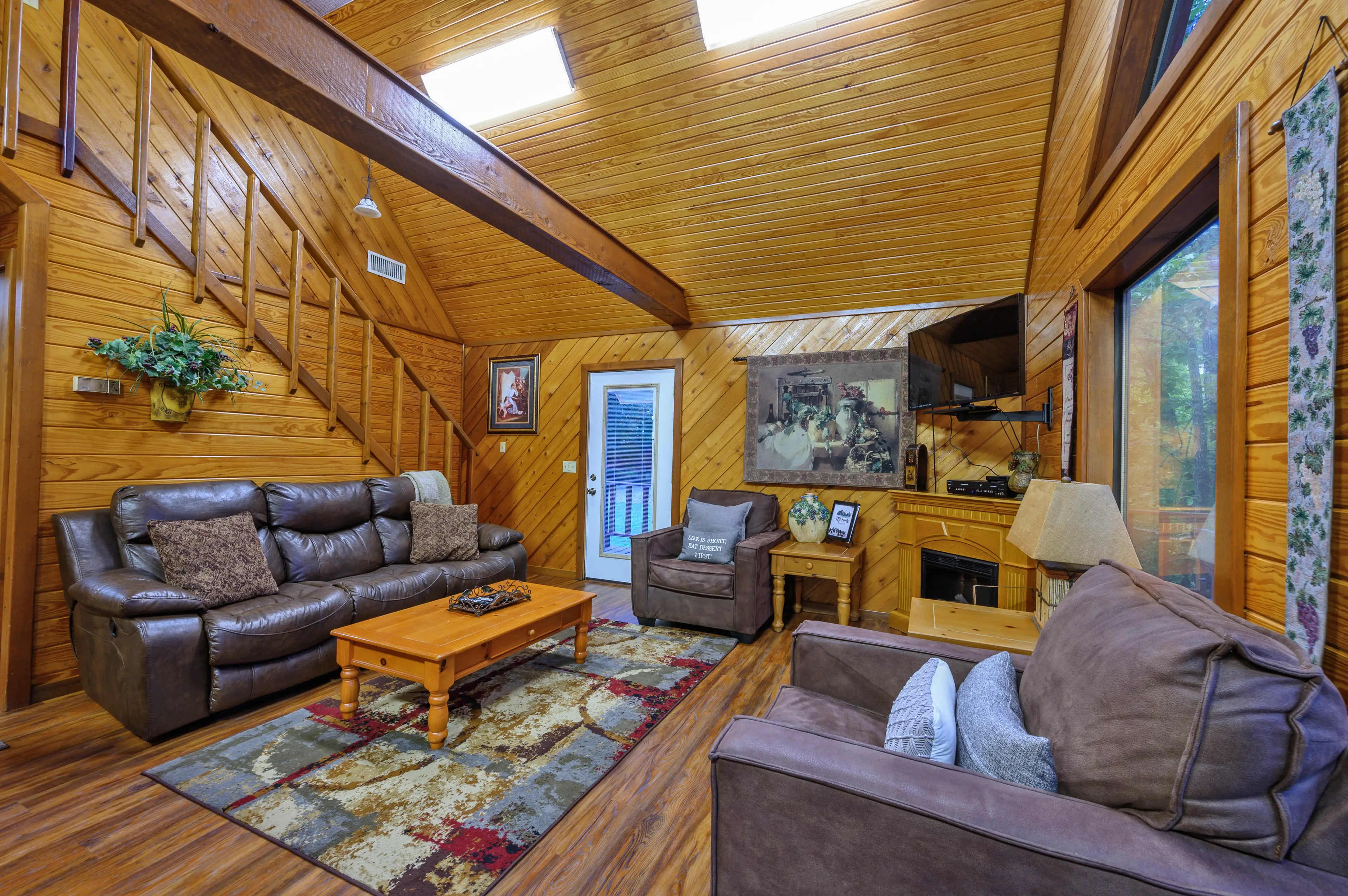 The stairs off the living room leading to the upstairs open bedroom.