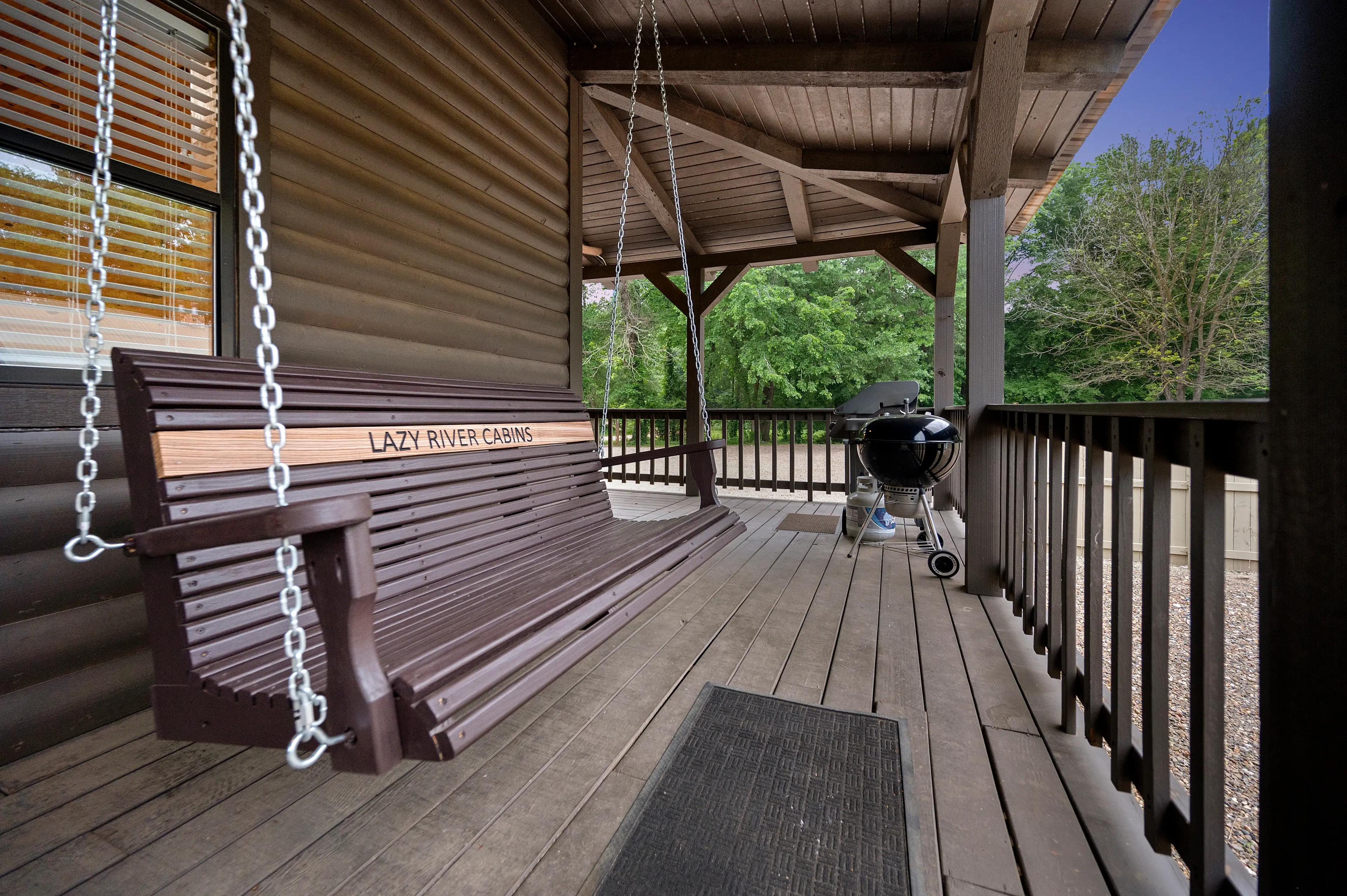 Porch swing to enjoy while grilling or for morning coffee.
