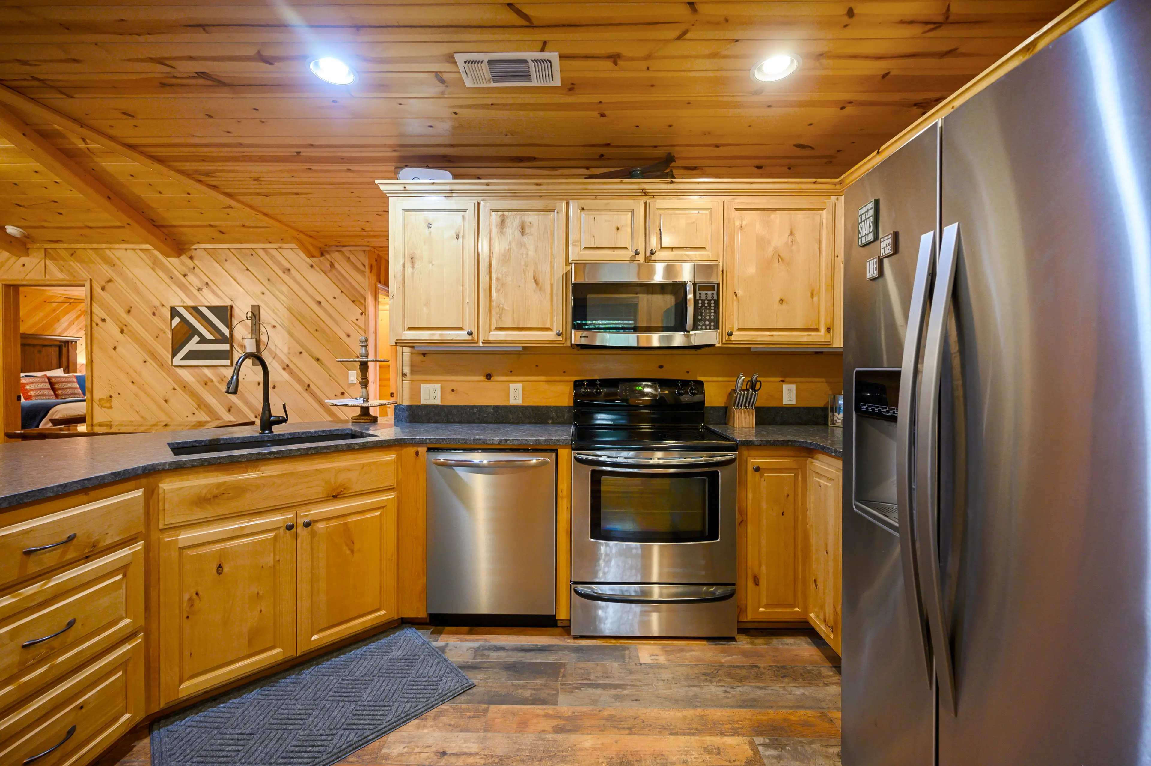 Full size stainless steel appliances including a dishwasher.