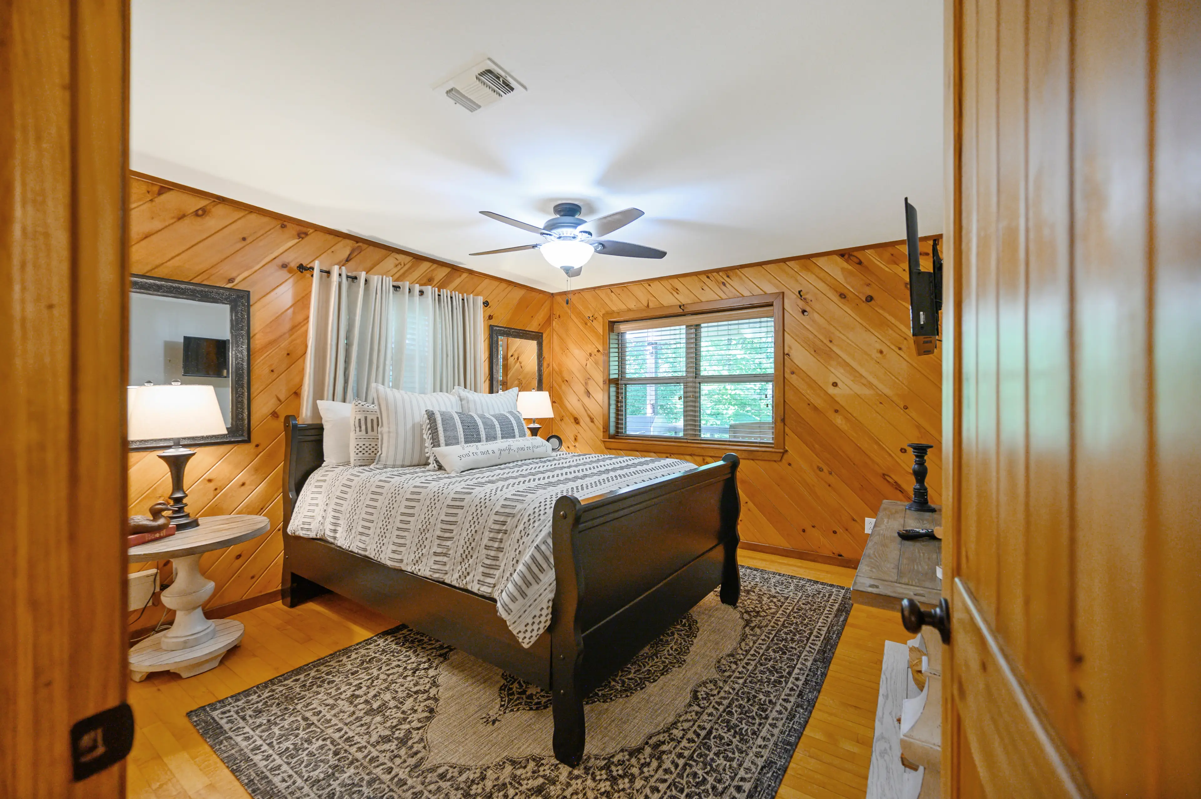 The first queen bedroom upstairs with a window overlooking the river.