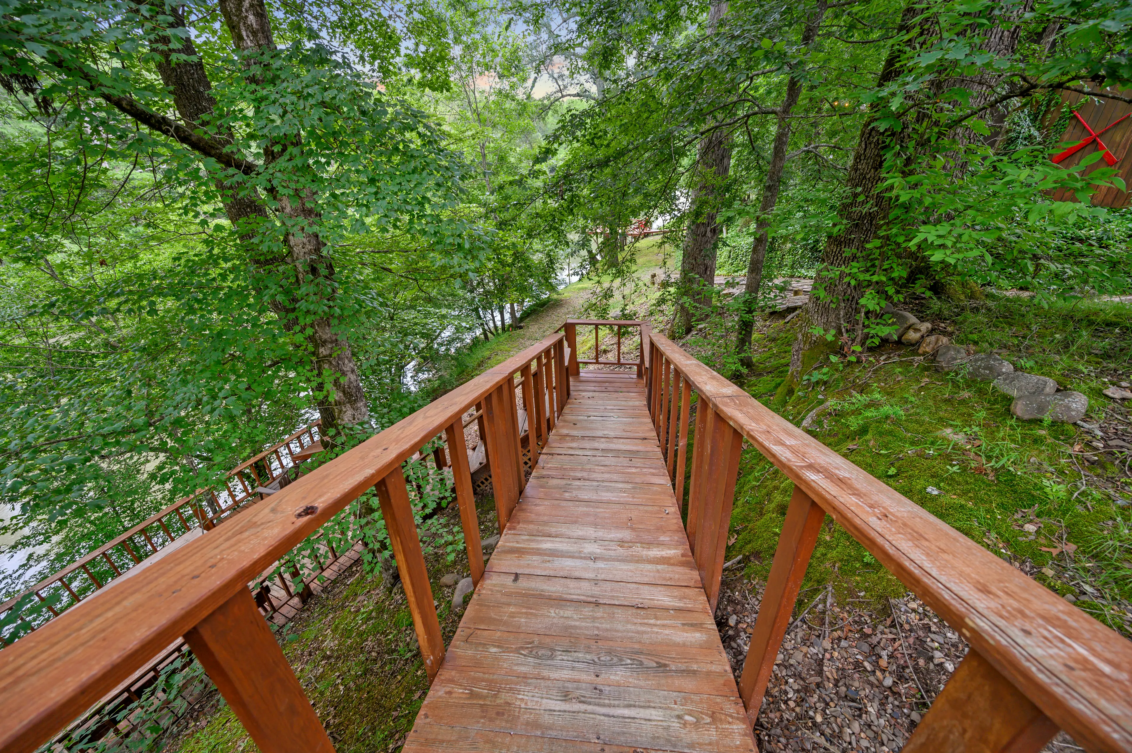 The boardwalk from the edge of the porch leading down to the river deck.