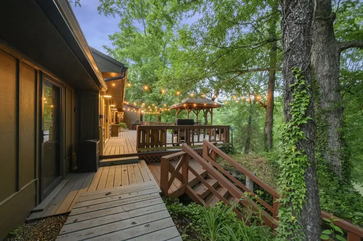 Large back porch with a wooden catwalk to the river