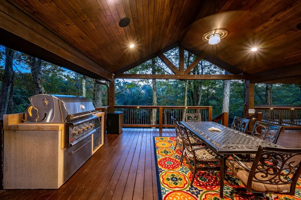 Professional grade propane grill and outdoor eating area, both with river views.