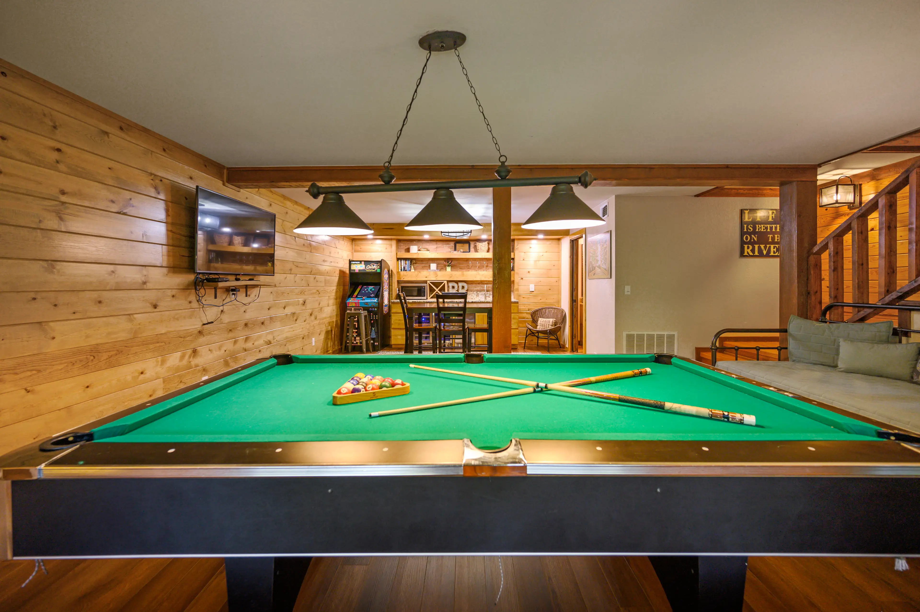 Arcade, pool table, and TV are all in the game room!