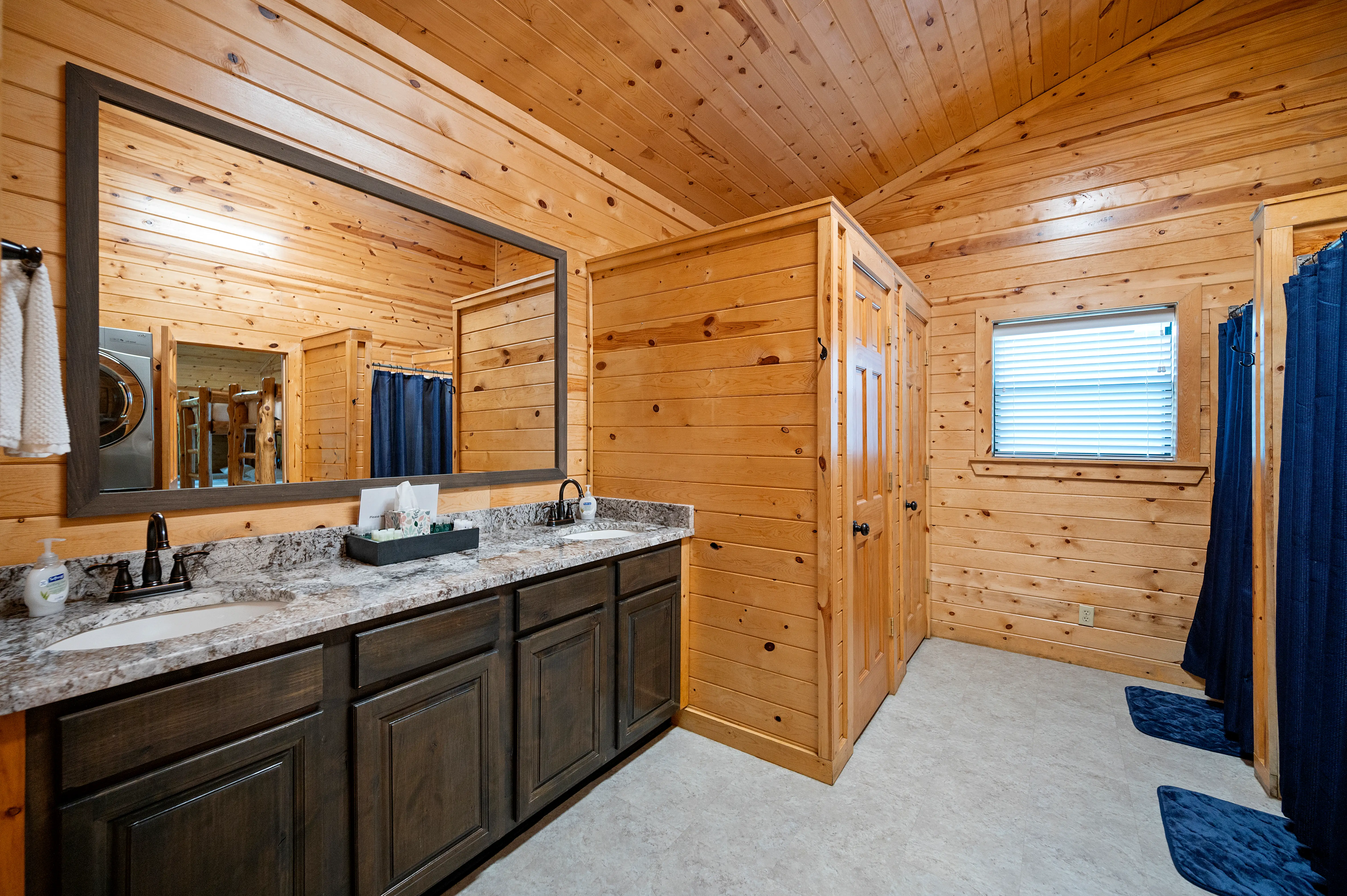 A total of 4 shower stalls and 4 water closets in the cabin.