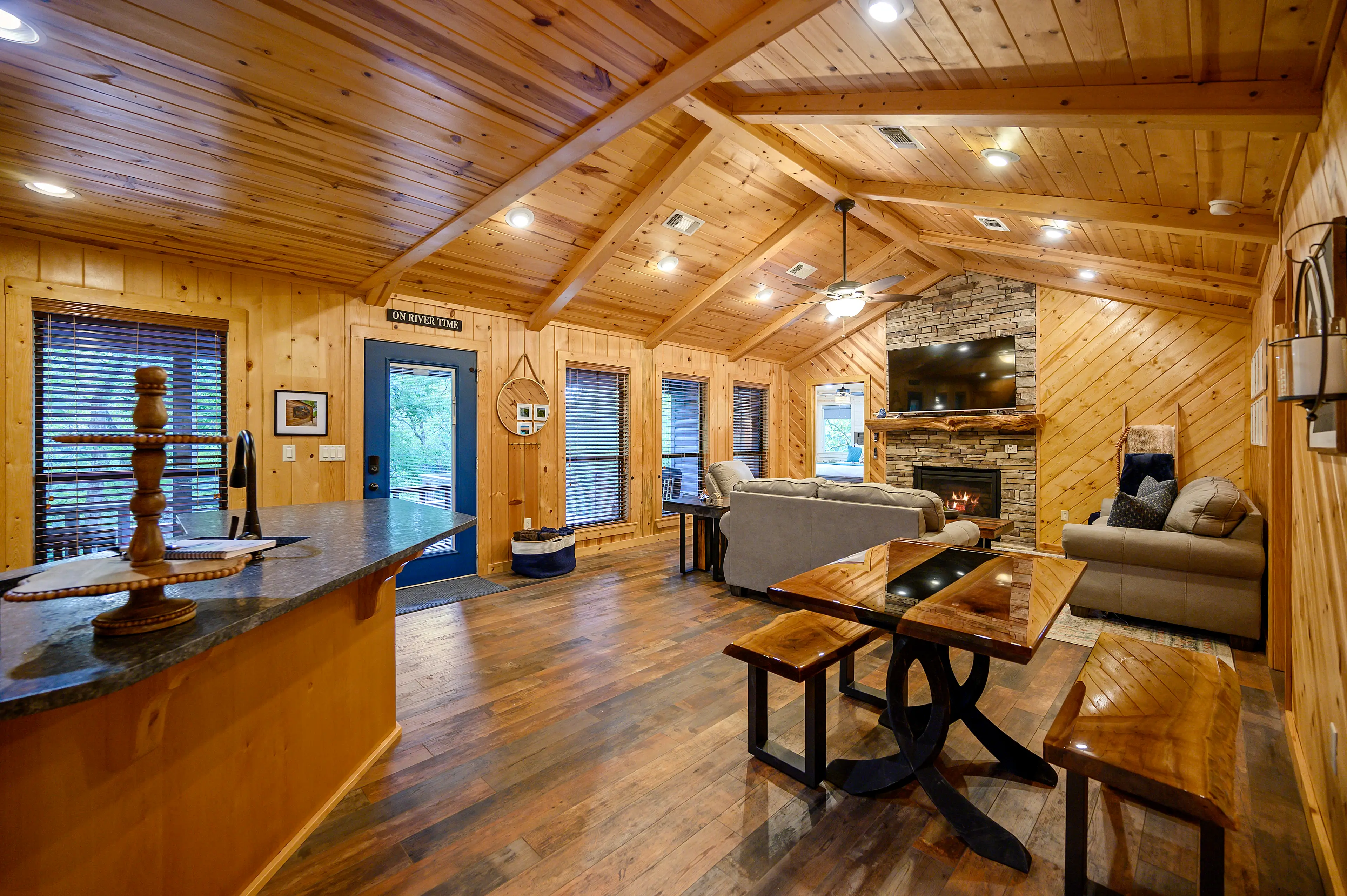 When you enter Hideaway, you'll see the open concept living area, dining table, and kitchen.