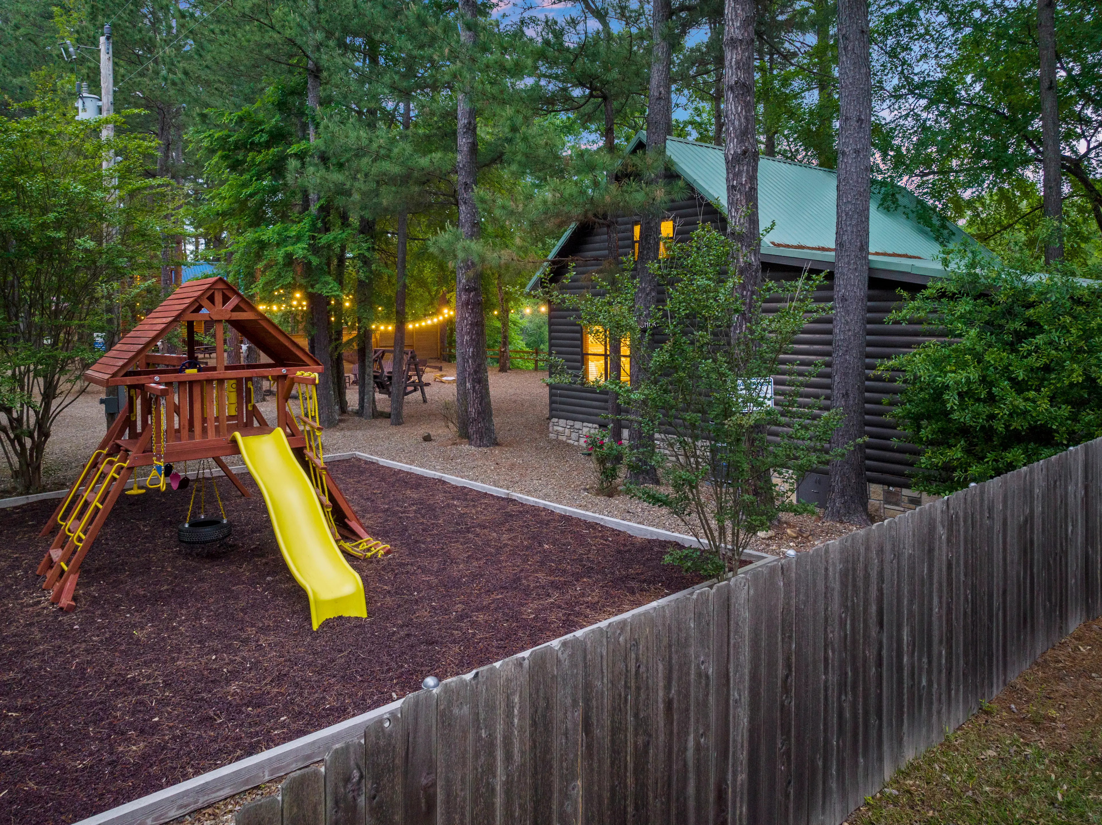 Sitting between the drive and the cabin is a playset for the kiddos!