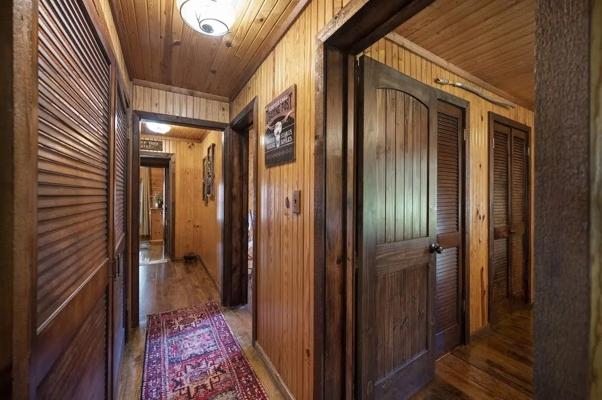 Hallway with washer/dryer leading to the bedrooms and second bath